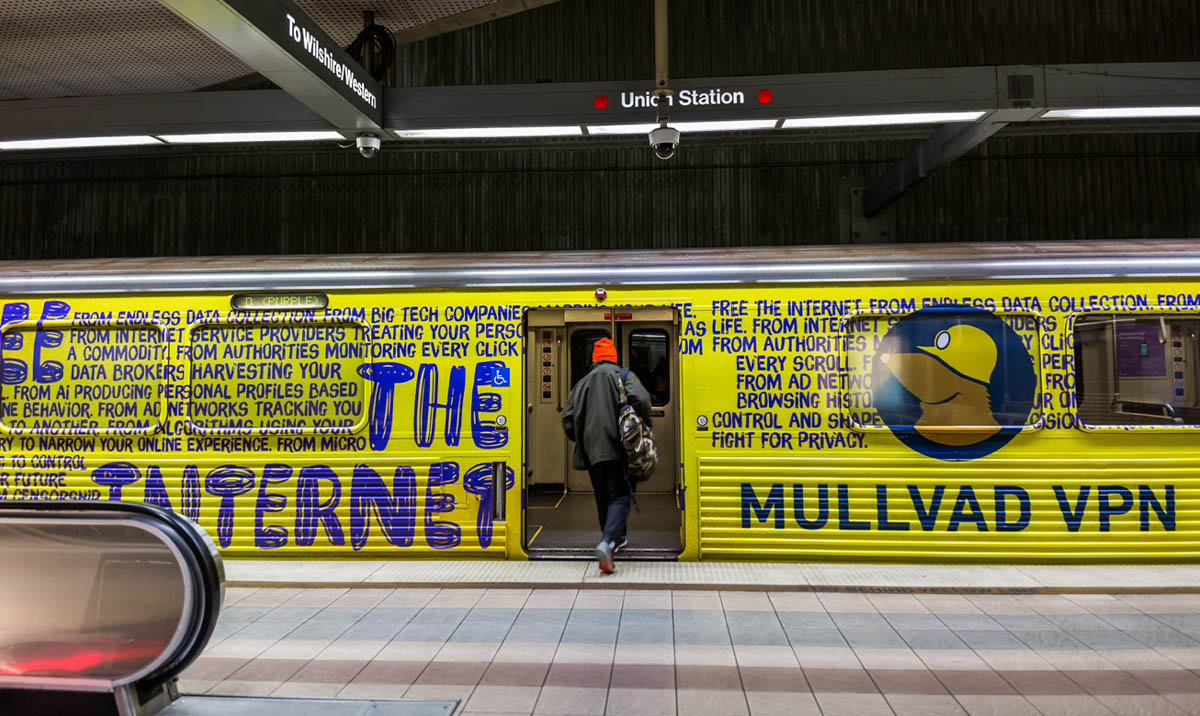 Yellow subway train at Union Station wrapped in a Mullvad VPN ad with mole mascot and text: FREE THE INTERNET, FIGHT FOR PRIVACY, MULLVAD VPN.