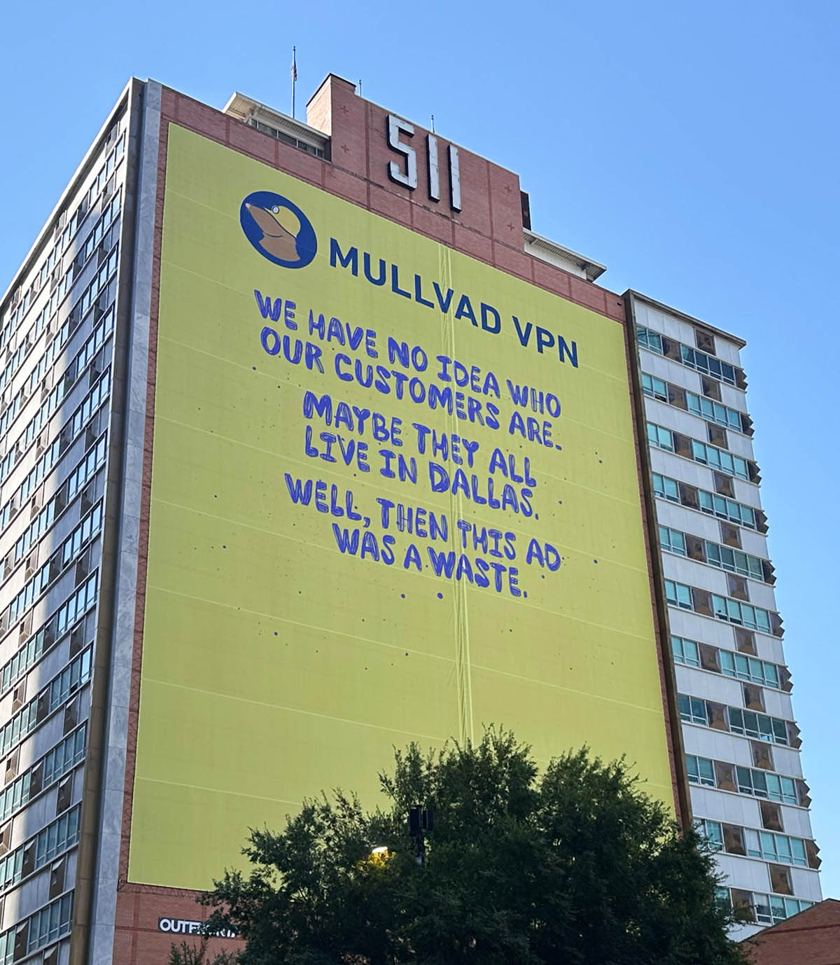 Large yellow Mullvad VPN billboard: WE HAVE NO IDEA WHO OUR CUSTOMERS ARE. MAYBE THEY ALL LIVE IN DALLAS. WELL, THEN THIS AD WAS A WASTE.